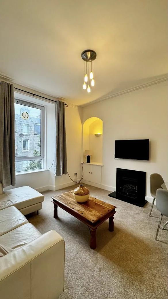 Living room in Rosemount with an arched alcove and granite view
